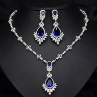 925 sterling silver blue sapphire necklace and matching earrings set on black background