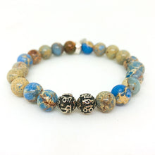 Load image into Gallery viewer, Angled view of Sea Blue Jasper Stone Silver Bead Bracelet 8MM with natural sea blue jasper gemstone beads
