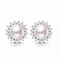 White pearl earrings with sparkling zircon halo in a silver setting