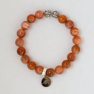 Sunstone silver bead bracelet 8MM with round natural beads and silver accents on a white background