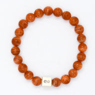 Sunstone infinity silver bracelet with warm golden-brown round beads and square infinity charm at bottom, white background
