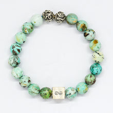 Load image into Gallery viewer, Turquoise infinity round silver bracelet with natural green-teal speckled beads, two carved silver beads on top and square infinity charm, white background


