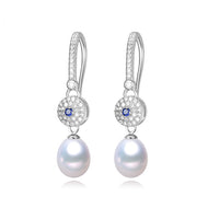 Silver pearl drop earrings with blue zircon accents and sparkling stone detailing