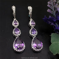 Purple gemstone silver earrings with three pear-cut stones and sparkling accents