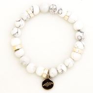 MysticFlavia white howlite bracelet flat view with dark brand charm pendant on white background