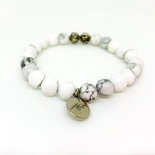Load image into Gallery viewer, MysticFlavia white howlite silver bead bracelet with MF charm, angled view white background

