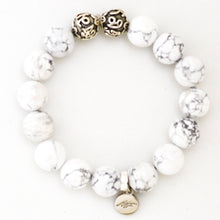 Load image into Gallery viewer, White howlite bracelet top view with decorative silver beads and MysticFlavia charm pendant

