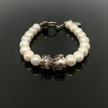 Load image into Gallery viewer, White Pearl Silver Toggle Clasp Bracelet displayed on a glossy black reflective surface

