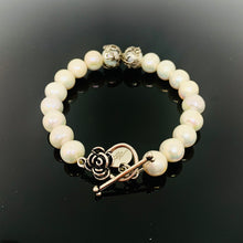 Load image into Gallery viewer, White Pearl Silver Toggle Clasp Bracelet featuring floral toggle clasp and silver bead details
