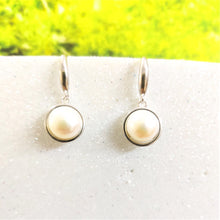 Load image into Gallery viewer, White pearl silver drop earrings displayed on a white background.
